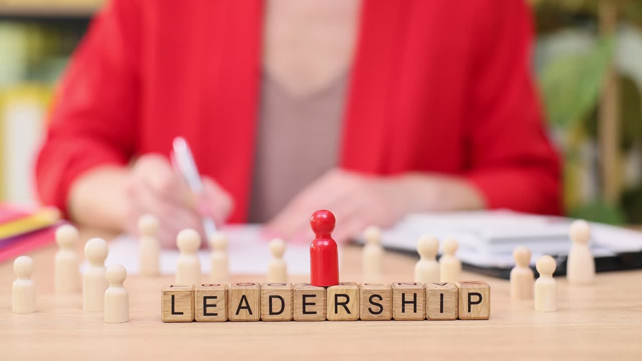 Leadership and Teamwork Concept with Wooden Figures and Blocks