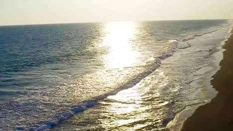 beautiful sunset in the beach with orange, blue and yellow colors.