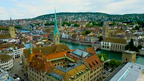 4k drone video of the historic grossmünster, fraumünster, and st. peter churches in downtown zurich, switzerland