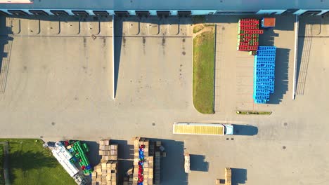 Aerial-view-of-warehouse-storages-or-industrial-factory-or-logistics-center-from-above