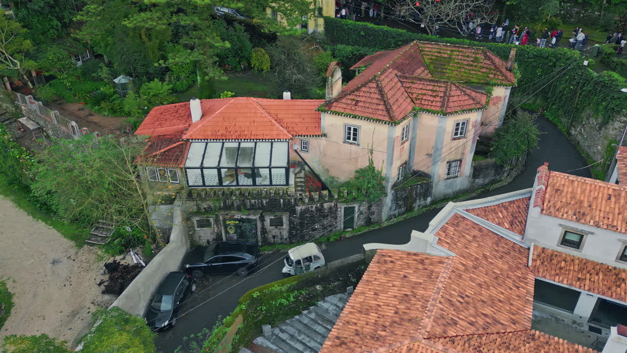 Tiled roof old buildings and serpentine roads highlight vintage village drone