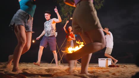 friends enjoying a nighttime beach bonfire party