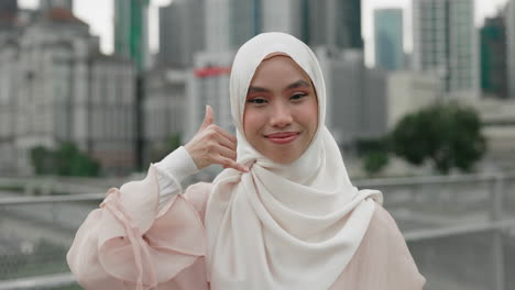 woman in hijab gesturing call