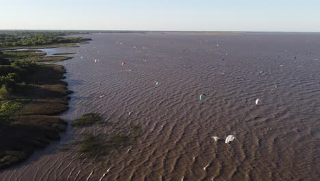 Many-Kitesurfers-Kitesurfing-On-Rio-De-La-Plata-River-At-Sunset,-Vicente-Lopez-Area-Park-Of-Buenos-Aires-In-Argentina