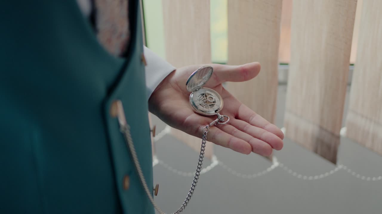 Groom holding an open pocket watch, highlighting timeless elegance and attention to detail