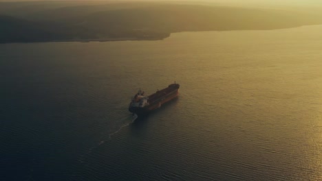 tugboat and cargo ship through the canal around the varna port, bulgaria