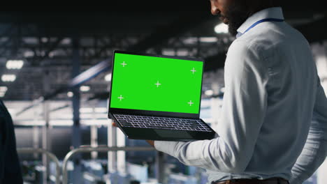 data center programmers on industrial platform using green screen laptop