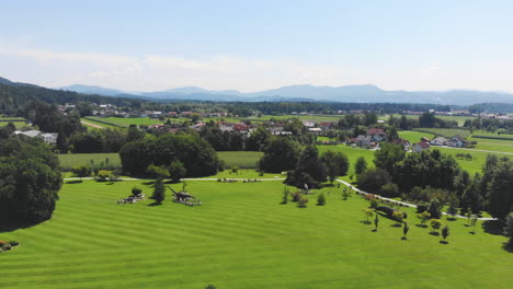 aerial slow descent pan left over the volcji potok arboretum on sunny day