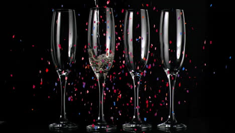 Animation-of-confetti-falling-over-champagne-glasses