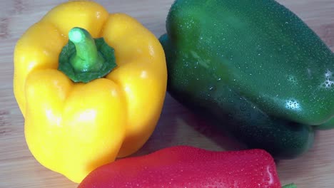 medium shot of fresh bell peppers rotating on a kitchen worktop