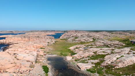 beautiful smooth granite shoreline of bohuslan under clear blue sky in gotaland, sweden