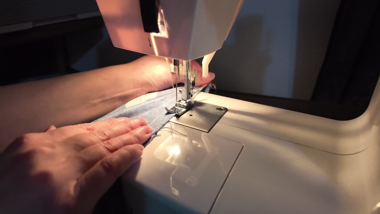 Slow motion video of crafting a fabric using the sewing machine at home
