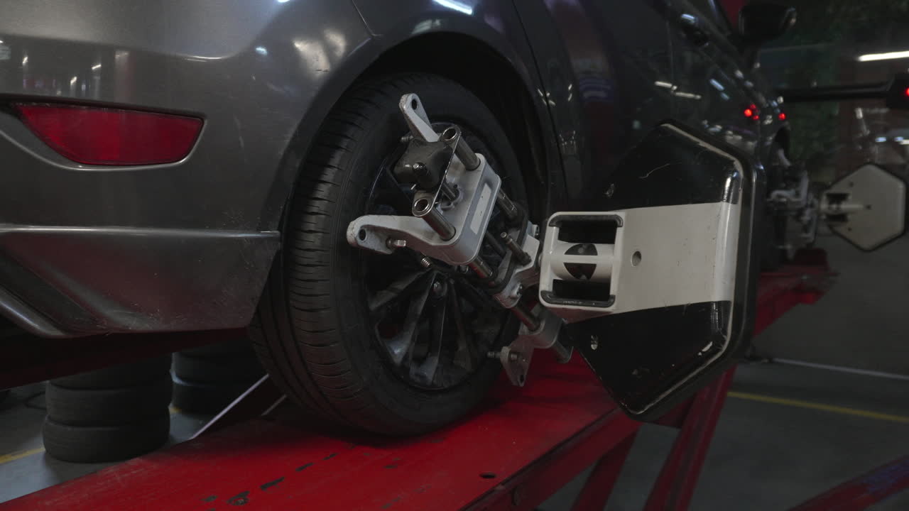 Car wheel with alignment sensor equipment in a mechanical workshop