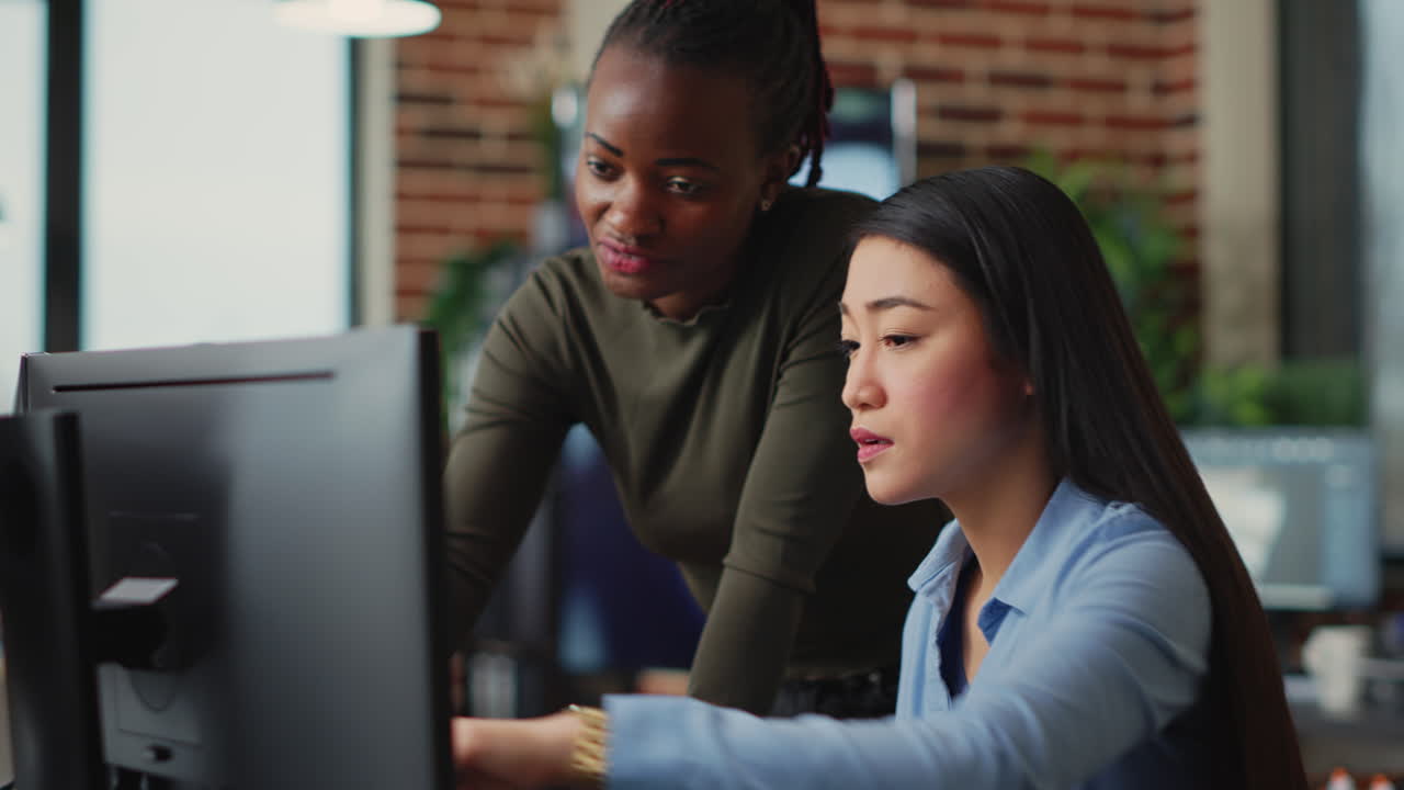 Multiethnic team of IT developers working on computers