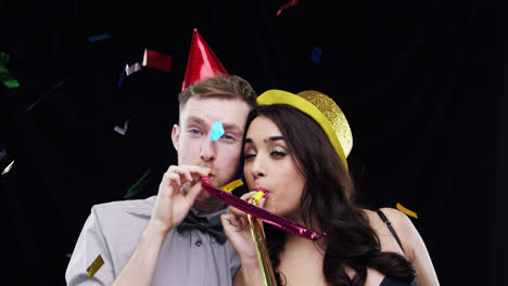 mixed race couple blowing slow motion party photo booth