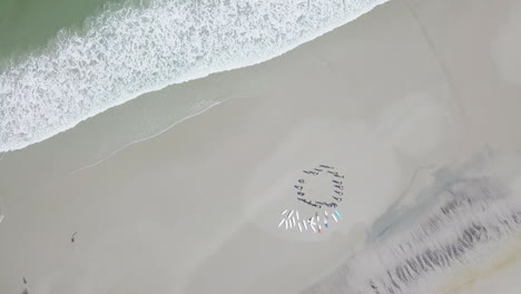 dramatic aerial of surfing along coast in south africa