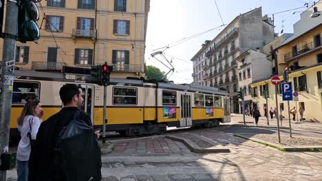 tram passing through a busy milan street