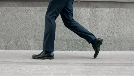 business man legs walking in black shoes. closeup black shoes walking outdoor