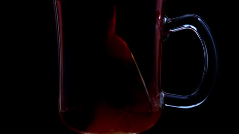 spoon stirring tea in a glass