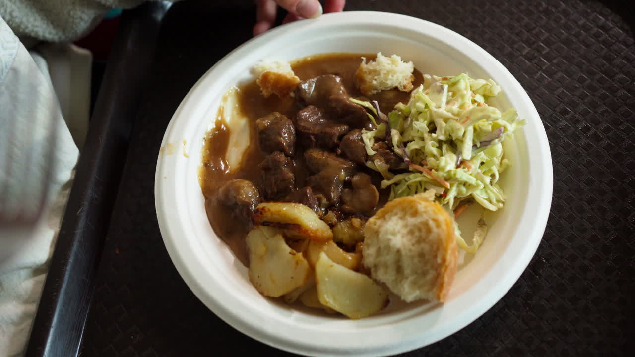 Serving Of Delicious Caribou Stew On Plate With Veggies And Bread On Side. high angle shot