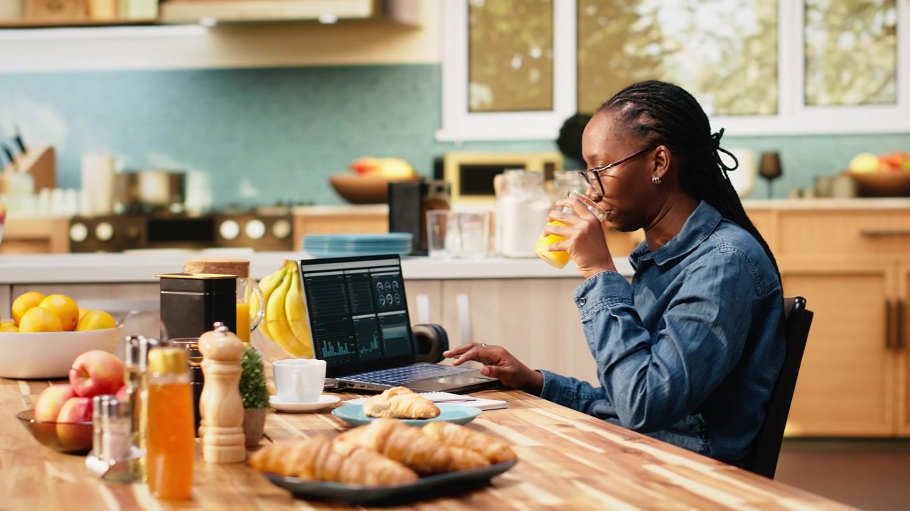 Woman worker takes analytics notes and manages projects on laptop