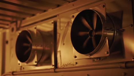 detailed look at industrial airflow equipment and ventilation systems in a dimly lit space featuring unique texture and mechanical components