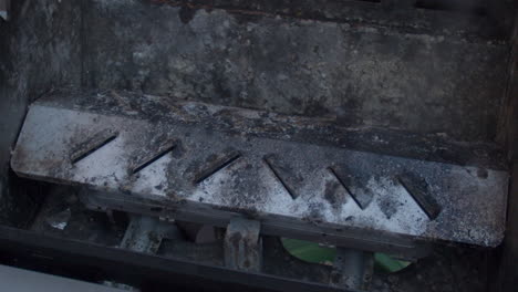 Cleaner-being-sprayed-on-dirty-barbecue-in-slow-motion