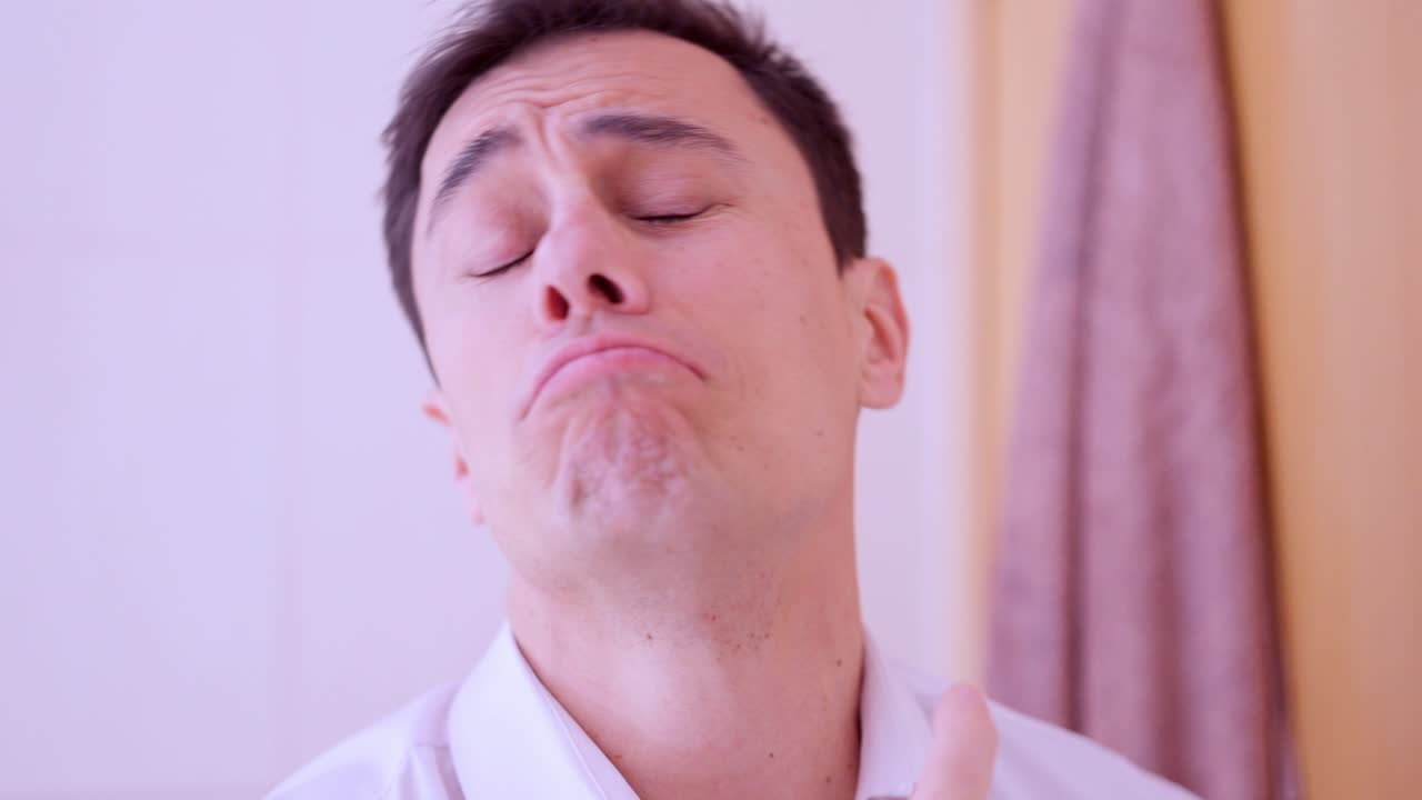 Businessman applying perfume and enjoying fragrance