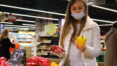 young blonde buys vegetables at the local market. organic fresh vegetables