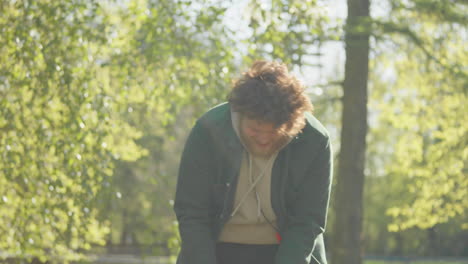 man playing tug-of-war with his dog in the park