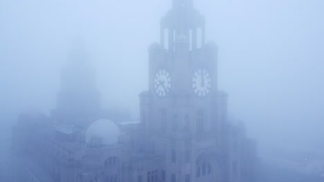 dense fog cover aerial view liverpool liver building in thick gloomy weather visibility rising upwards