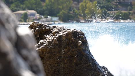 Close-up-of-foamy-waves-crashing-into-a-cliff-on-the-beach-of-Corfu-Island