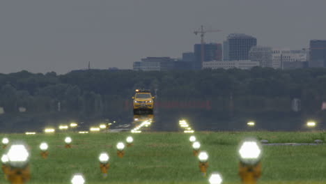 airport runway with maintenance vehicle