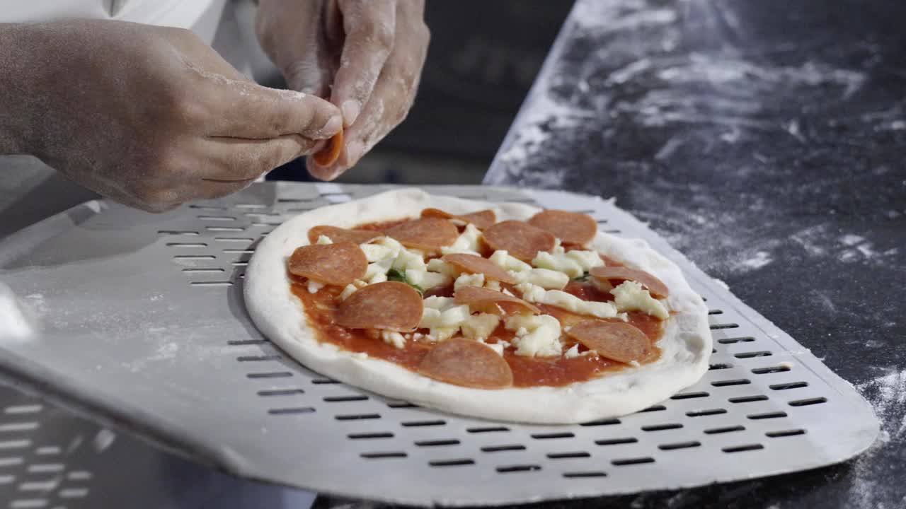 Pizza being prepared in the Dominican Republic, showcasing the dough, ingredients, and preparation process