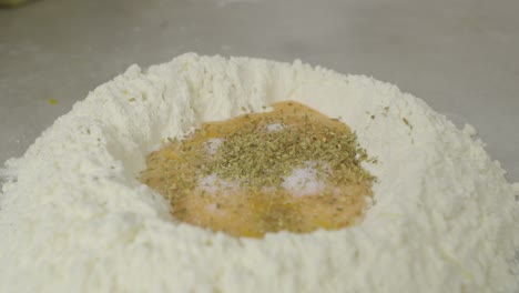 adding spice to flour with egg yolks inside