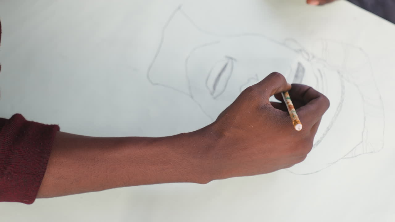 Artist sketches vividly. Creative artist working on portrait. Skilled creator drawing headwrap with bold outlines. Black artist passionately sketching headwrap portrait with rhythmic motion