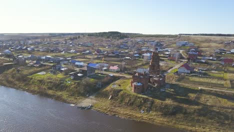 aerial view of a russian village with a ruined church