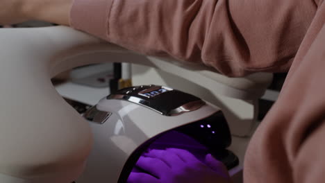 woman getting a manicure at a nail salon