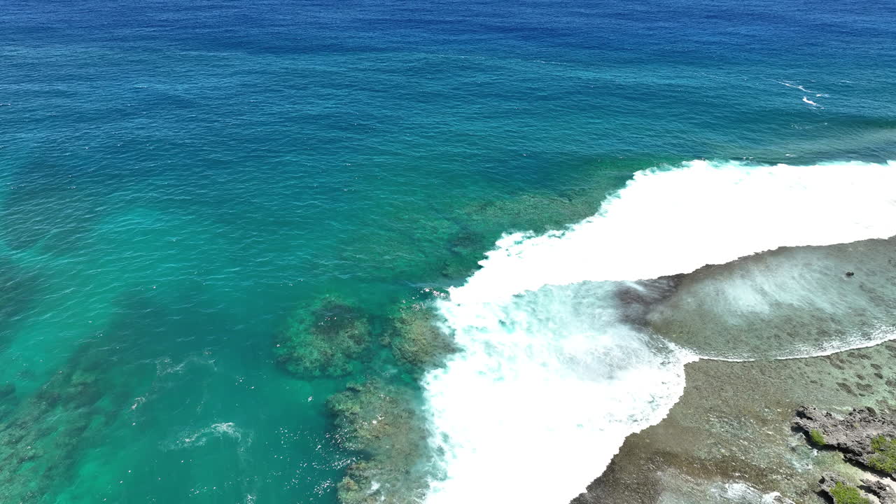 Avana passage opening in Rarotonga Cook Islands with crashing waves on rocky outcrops