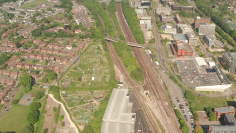 Aerial-shot-over-Southwestern-train-arriving-in-the-outskirts-of-Basingstoke-town