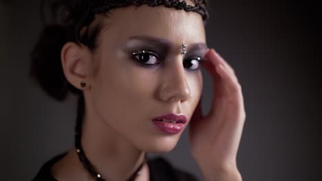 young beautiful girl posing in front of the camera her hair is in the form of a braid frame