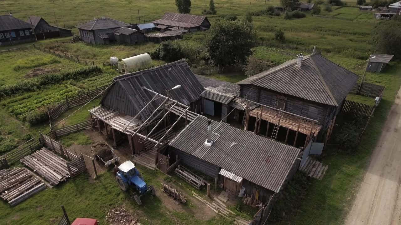 Aerial view of a rural village with wooden houses and farm buildings
