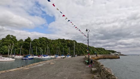 scenic harbour with boats and cloudy sky