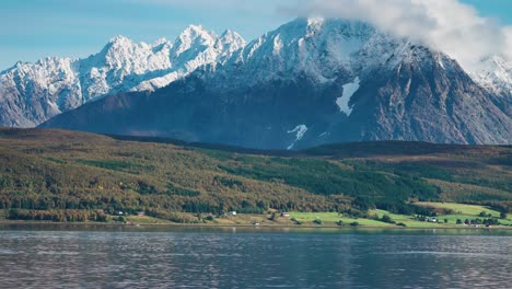 magnificent snow-covered lyngen alps tower above the valley and the fjord