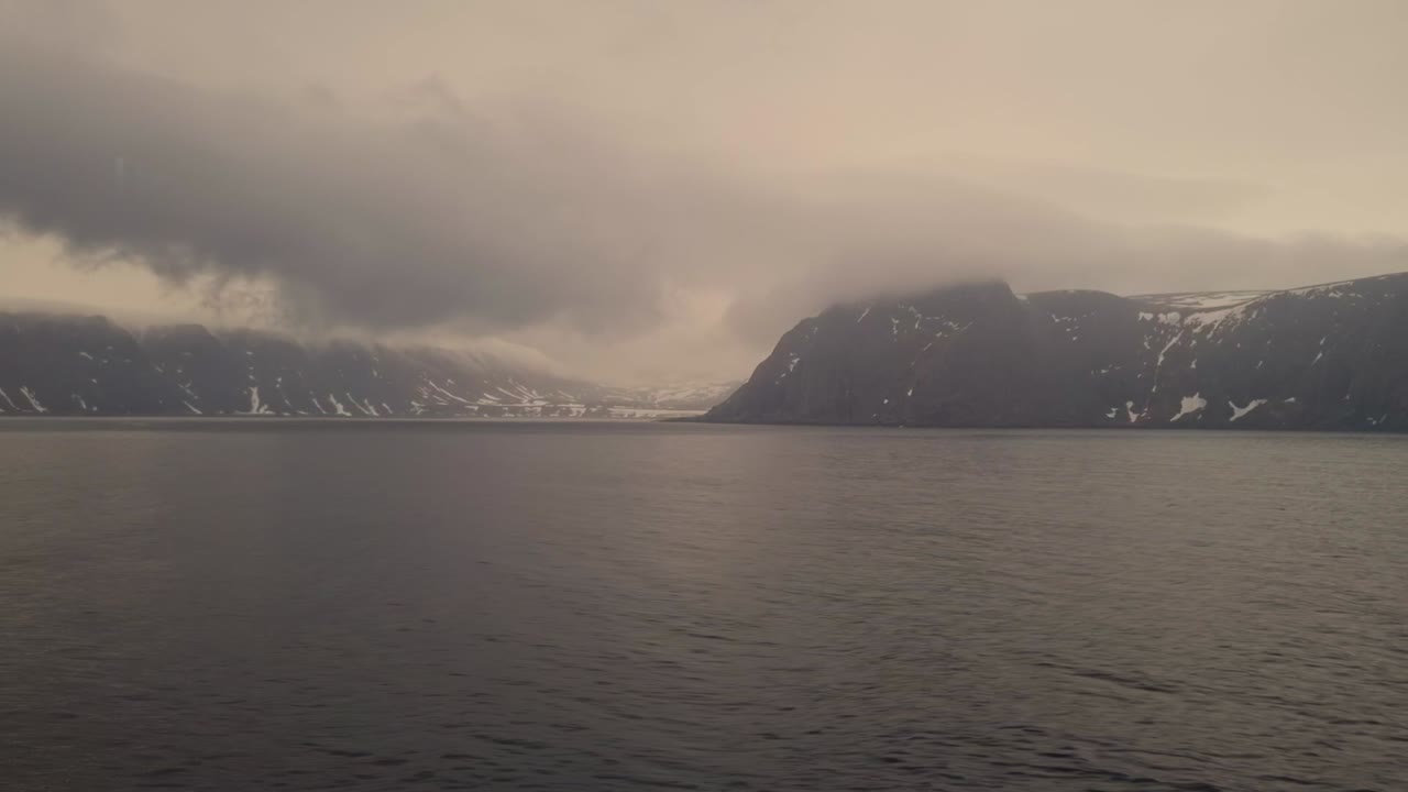 The view of clouds and mist from the deck of a cruise ship sailing along the coast of Norway