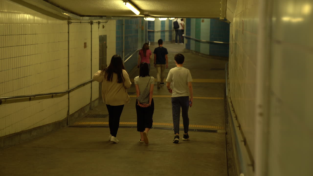 People walking through an underground subway passage