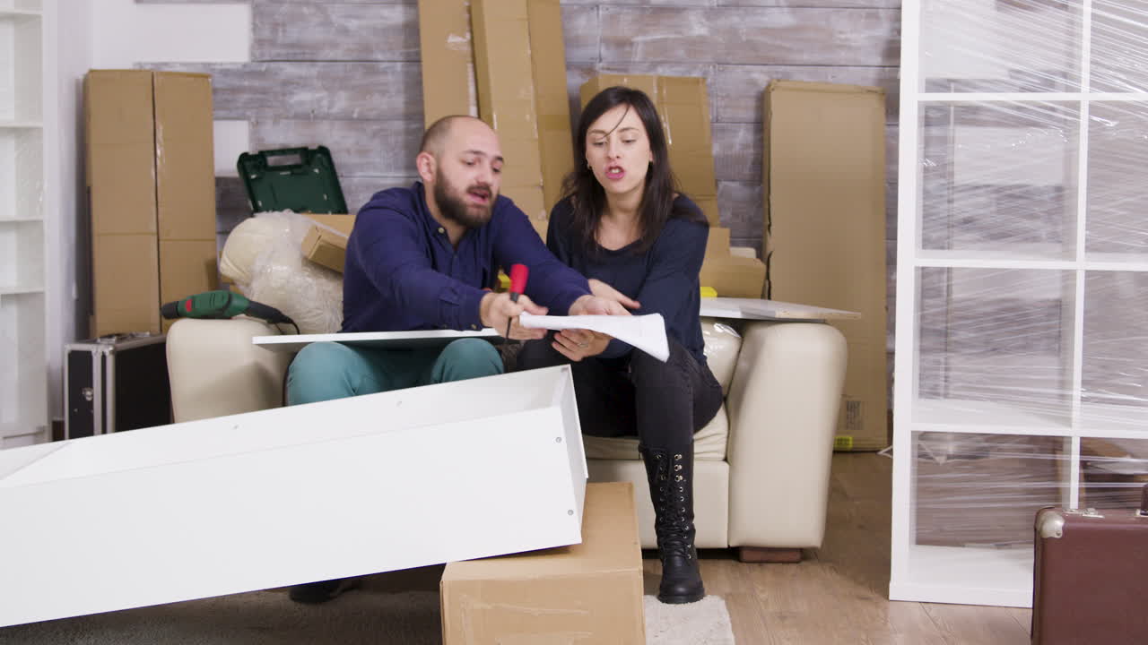 Couple Assembling Furniture in New Home