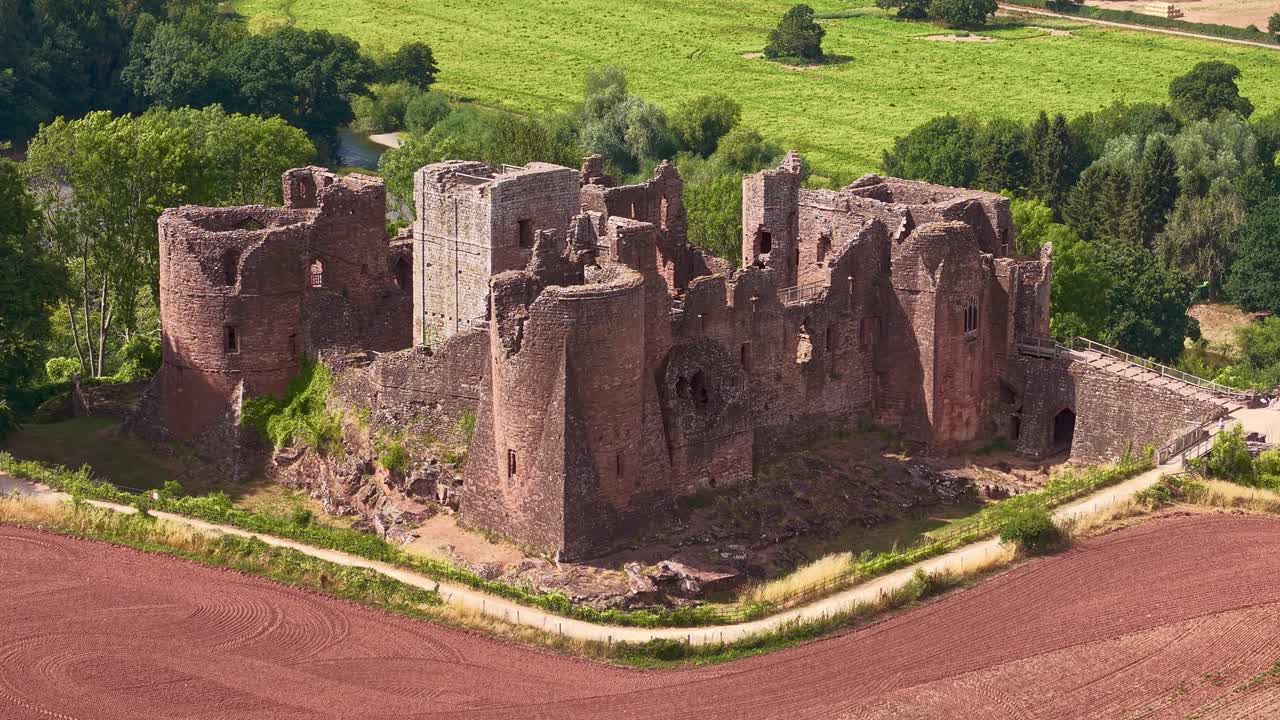 Aerial view of a historic castle ruins in a rural setting