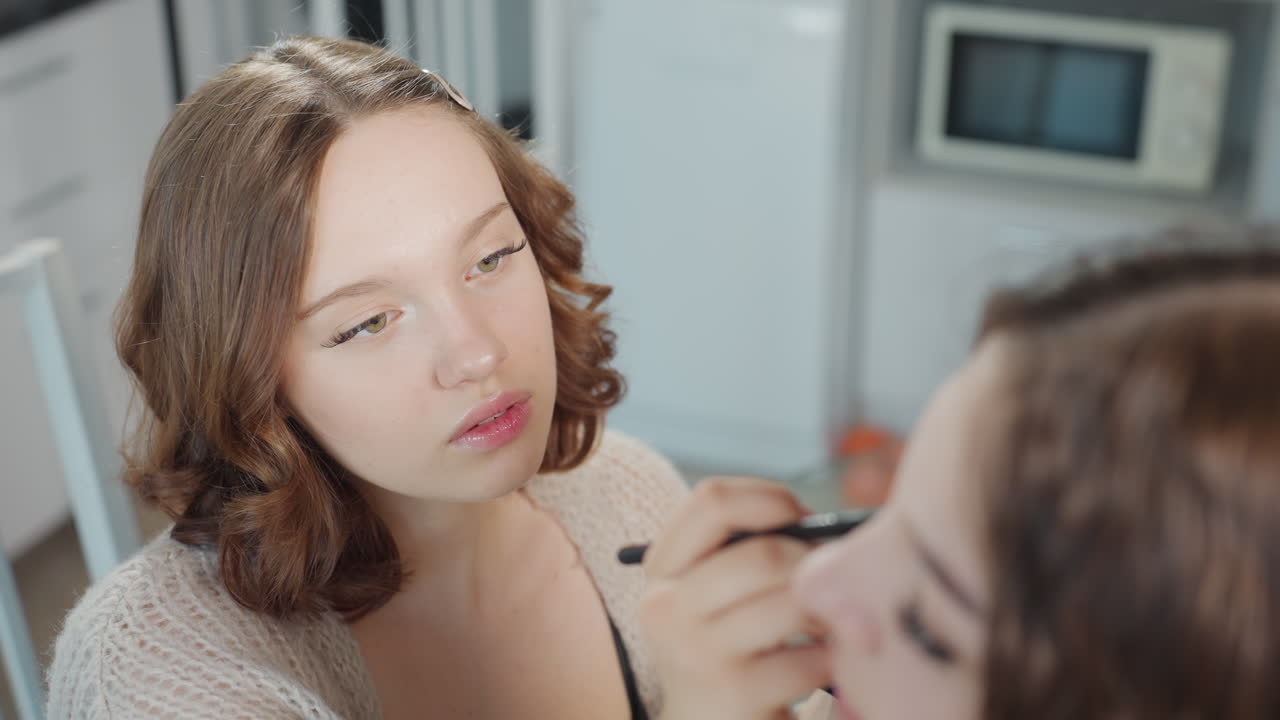 White Woman Applying Lipstick And Compact Checks, Preparing For Evening Event, Soft Kitchen Studio Background, Detailed Color Choice, Focused Pout And Final Polish, Intimate Preparation Moment