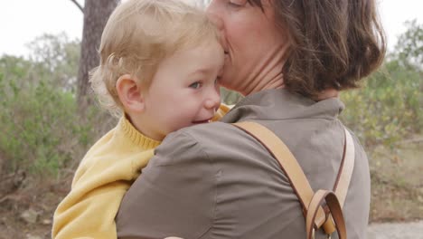 Caucasian-woman-holding-baby-in-forest